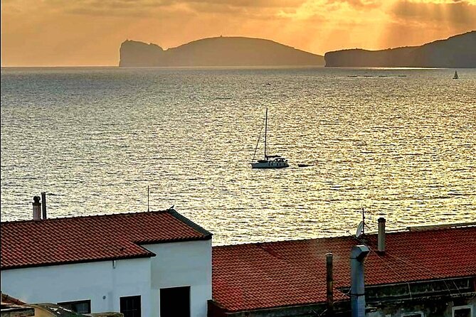 2-hour sunset tour by sailboat with aperitif. - Sailing beneath Alghero’s old walls