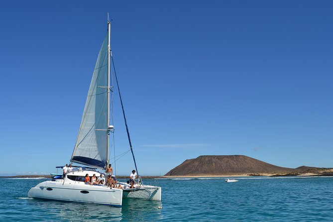 Exclusive Sailing Catamaran Experience to Lobos Island with lunch - Paella, Fruit, and Drinks on Deck