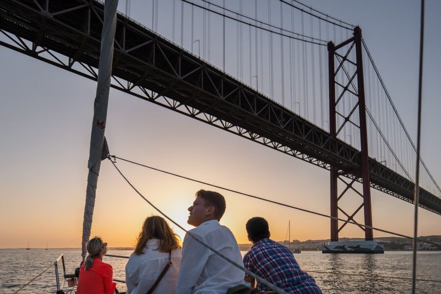 Lisbon: Daytime/Sunset/Night City Sailboat Tour with Drink - Under the 25 de Abril Bridge