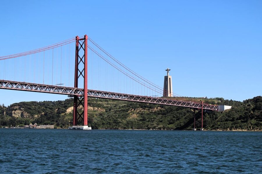 Lisbon On a Sailboat - Cultural Facts and Sailing Experience - Christ the King and Almada Across the River