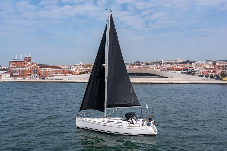 Lisbon: Private Sailboat Tour on the Tagus at Sunset - Sailing beneath the bridge with Cristo Rei ahead