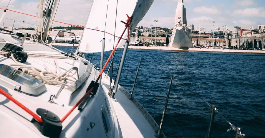 Lisbon: Yacht Sailing Tour With Portuguese Wine and History - Under the 25 de Abril Bridge and toward Belém