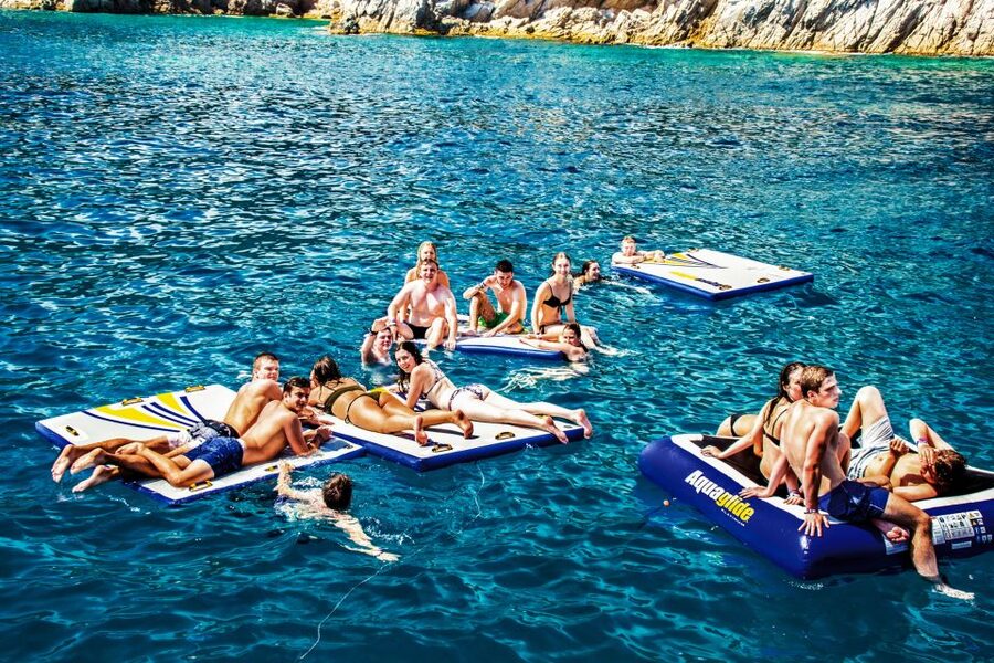 Lloret de Mar: Catamaran Sailing Cruise with BBQ and Drinks - The first hour: cliffs, caves, and fishing villages