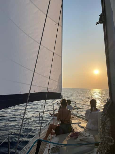 Mykonos: Sunset Sail Cruise to Rhenia, Beach Hopping, Dinner - Swimming and snorkeling from the yacht