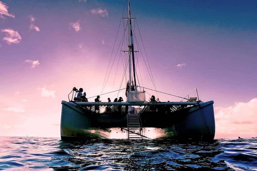 Oahu: Waikiki Sunset Catamaran Sail and Swim - Leaving Waikiki beneath the pink sails
