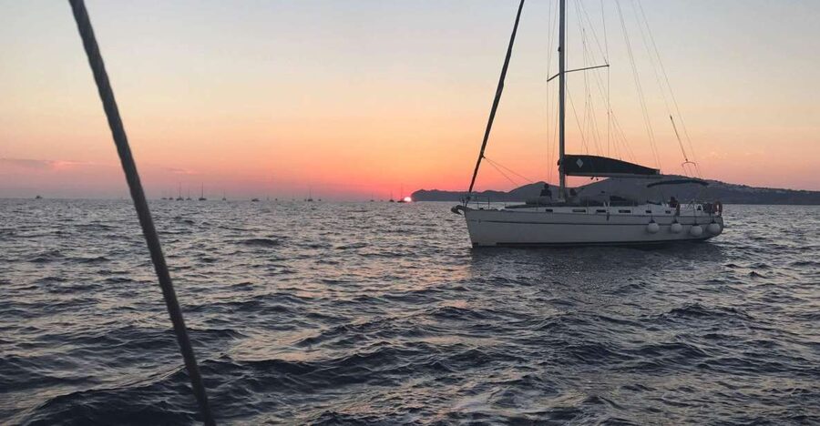 Santorini: Private 5-Hour Sunset Sailing Tour with Dinner - Entering the caldera beneath the lighthouse