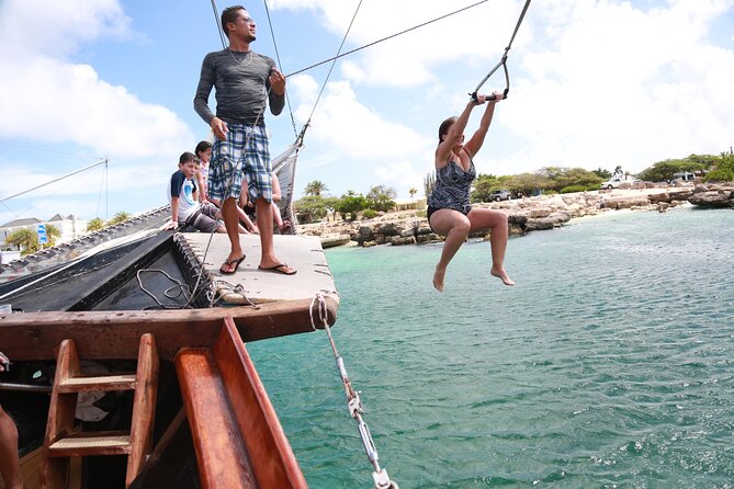 Set Sail in Aruba: Jolly Pirate Cruise with Snorkel Adventure - The rope swing turns the boat into an amusement ride