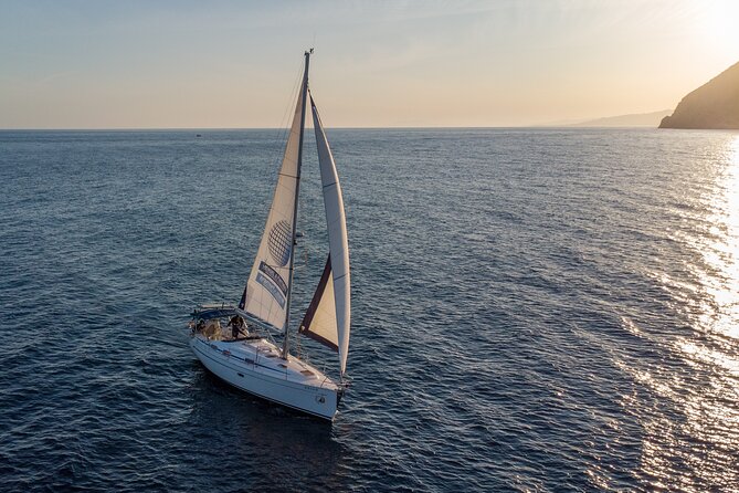 Sunset sailing along the cliffs of Maro- Private - The Sunset Is the Main Event