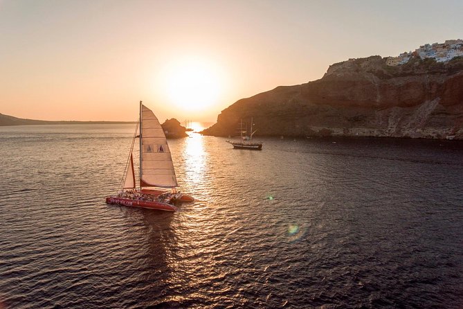 Sunset Sailing Catamaran Cruise in Santorini with BBQ and Drinks - The volcano and hot springs set the scene